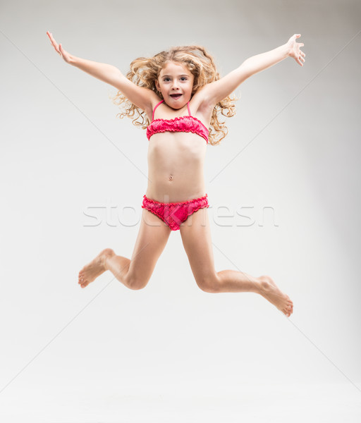 Agile exuberant little girl leaping in the air Stock photo © Giulio_Fornasar