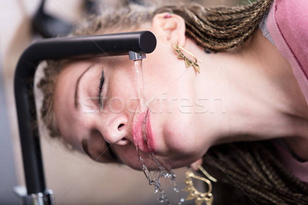 Attractive woman drinking water from a tap Stock photo © Giulio_Fornasar