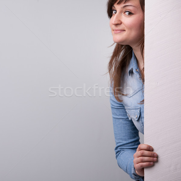 Nice girl showing up behind the white wall Stock photo © Giulio_Fornasar