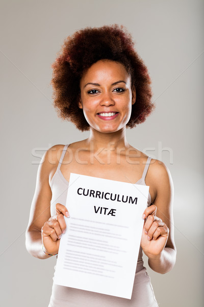 Stock photo: young woman showing her curriculum vitae