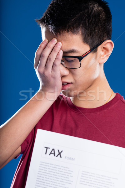 asian man worried by a tax form Stock photo © Giulio_Fornasar