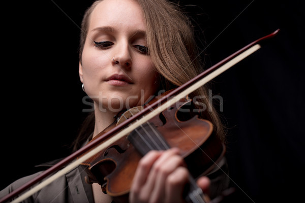 Stock photo: passionate violin musician playing on black background