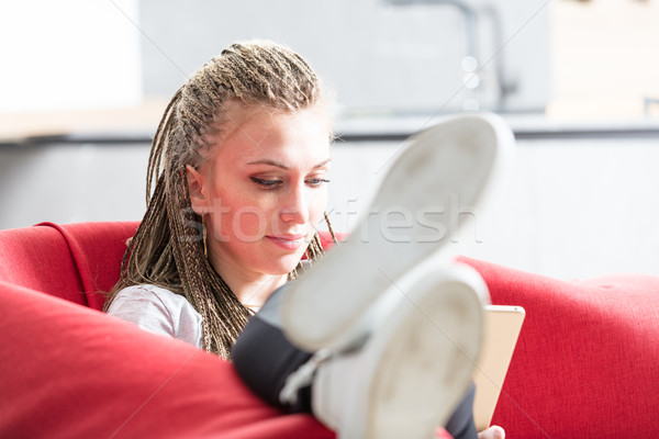 relaxed woman using her laptop on an armchair Stock photo © Giulio_Fornasar