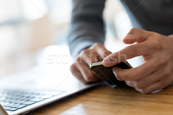 Man hands scrolling cell phone in office Stock photo © Giulio_Fornasar