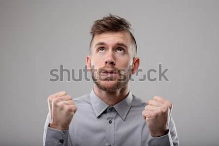 Stock photo: Intense bearded young man clenching his fists