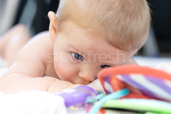 Little newborn baby eyeing its colorful toys Stock photo © Giulio_Fornasar