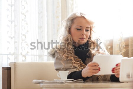 blonde woman reading on a tablet Stock photo © Giulio_Fornasar