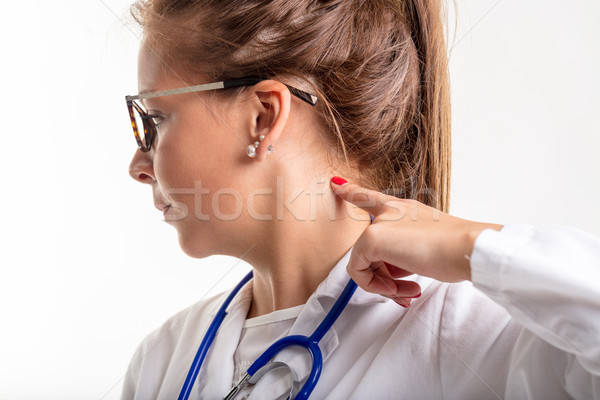 Female doctor pointing to the back of her neck Stock photo © Giulio_Fornasar