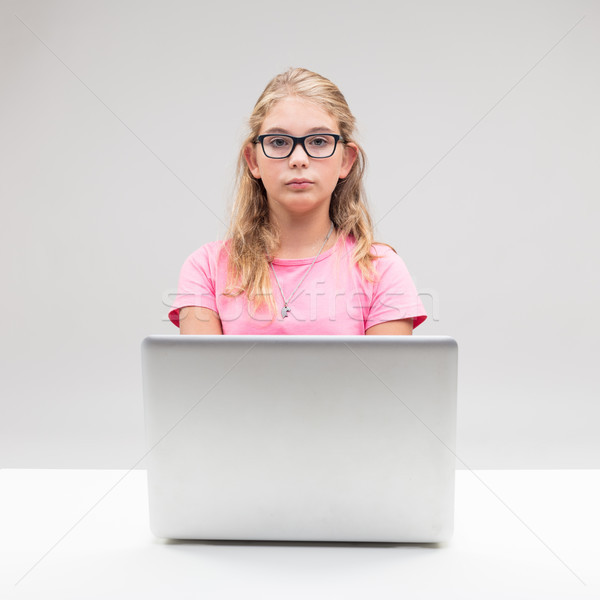 girl on eyeglasses using a laptop computer Stock photo © Giulio_Fornasar