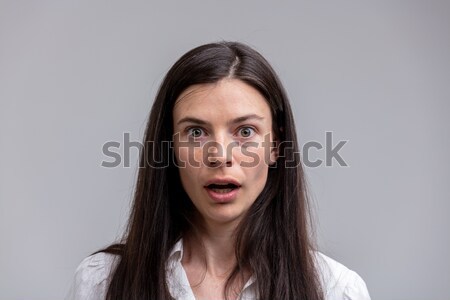 Portrait of young long-haired astonished woman Stock photo © Giulio_Fornasar