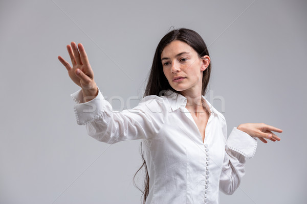 Imperious haughty woman flicking a hand in disdain Stock photo © Giulio_Fornasar