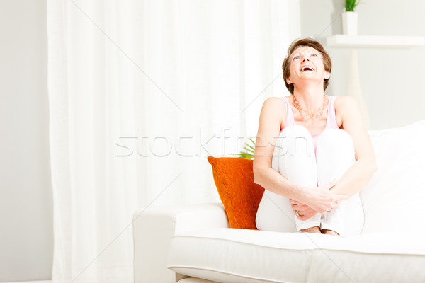 Attractive vivacious woman enjoying a laugh Stock photo © Giulio_Fornasar