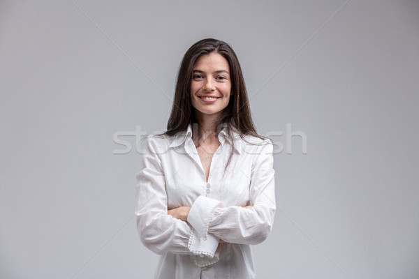 Smiling woman standing with arms crossed Stock photo © Giulio_Fornasar