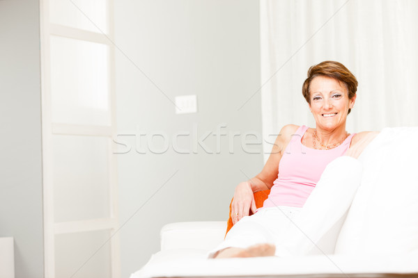 Happy confident woman relaxing on a couch Stock photo © Giulio_Fornasar