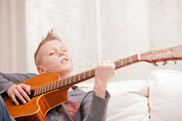 little boy is very good at playing guitar Stock photo © Giulio_Fornasar