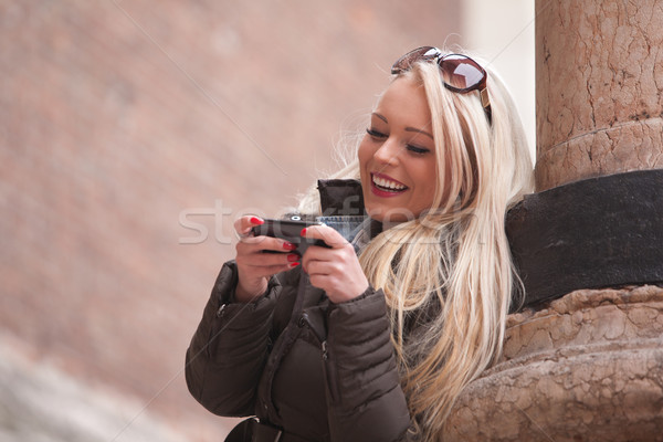 blonde girl outdoors with her mobile phone Stock photo © Giulio_Fornasar