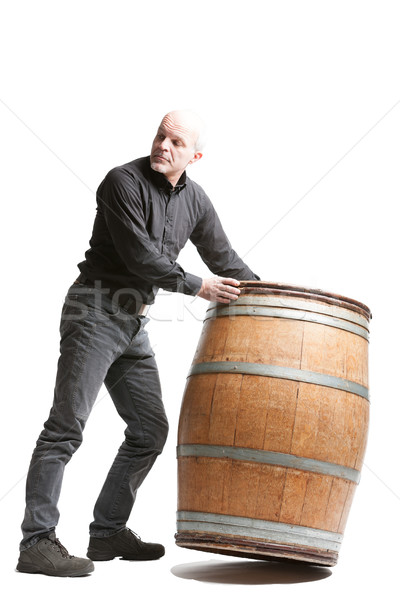 Middle-aged man tilting a wooden cask or barrel Stock photo © Giulio_Fornasar