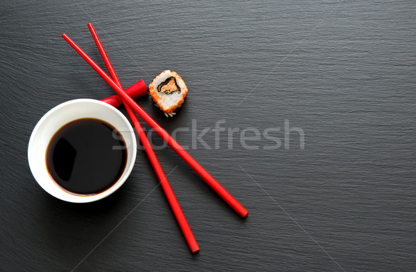 Stock photo: Soy sauce with red chopsticks