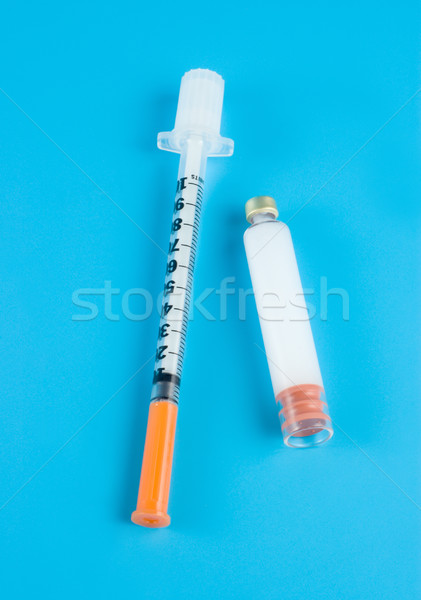  Insulin and syringe on a blue background Stock photo © Givaga