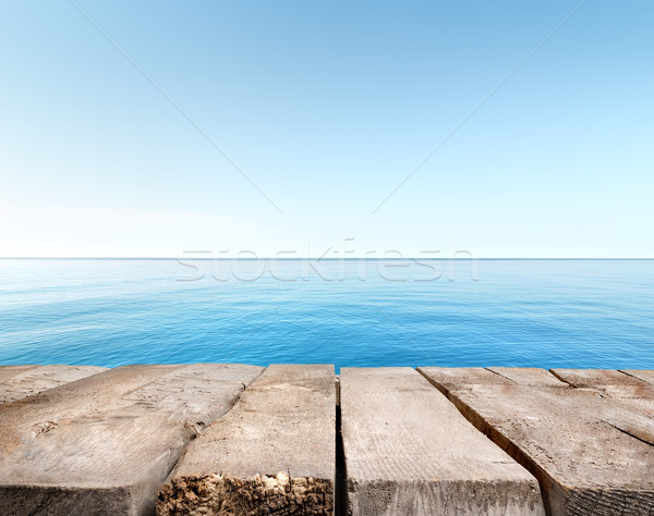 Blue sea and wooden pier Stock photo © Givaga