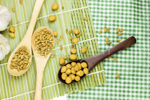 Sunflower seeds and nuts coated on spoon. Stock photo © Gloszilla