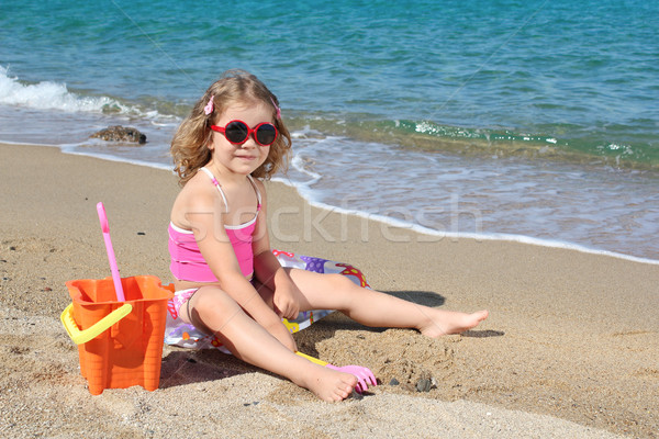 little girl with sunglasses playing on beach Stock photo © goce