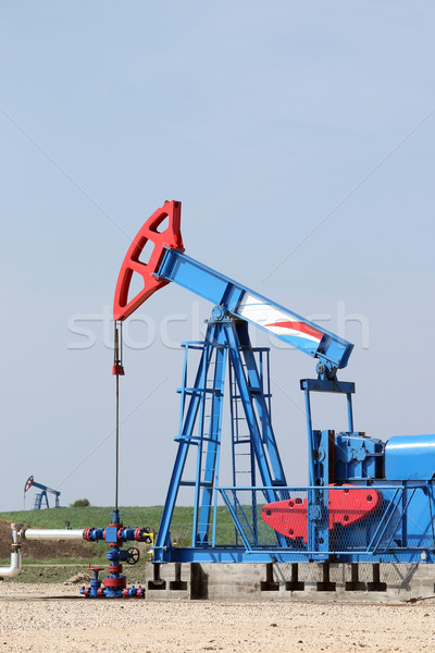 two oil pump jack on oilfield Stock photo © goce