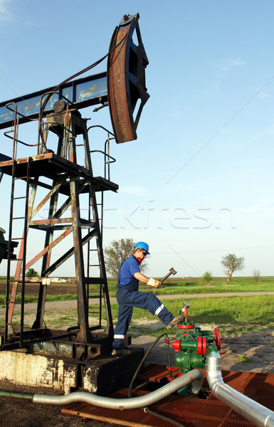 oil worker with hammer on oilfield Stock photo © goce