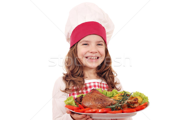 Stock photo: happy little girl cook with big turkey drumstick