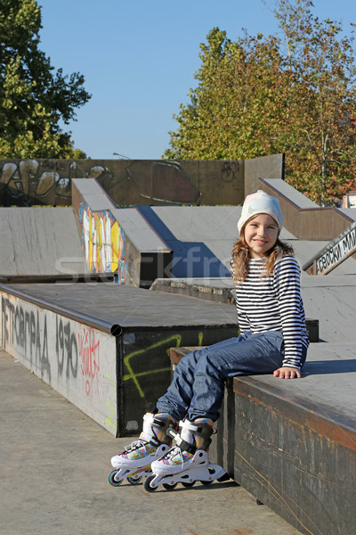 happy little girl with rollerskates on playground Stock photo © goce
