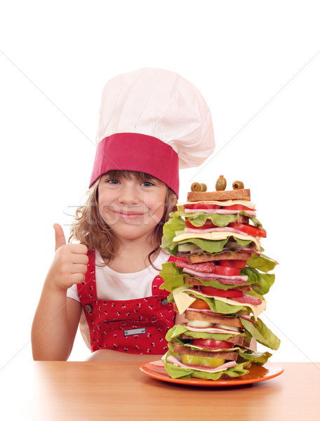 Little girl cozinhar alto sanduíche polegar para cima Foto stock © goce