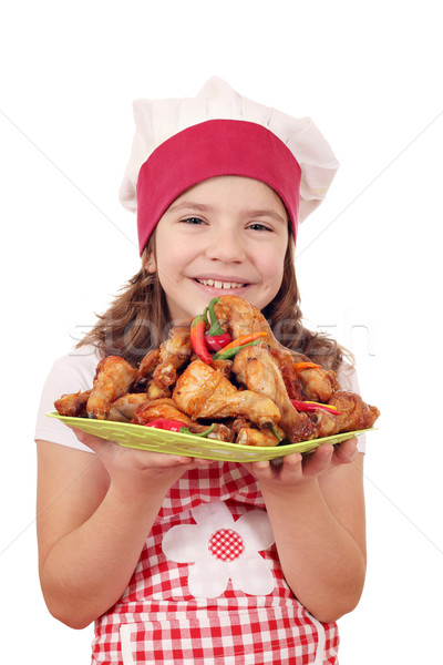 happy little girl cook with roasted chicken drumstick on plate Stock photo © goce