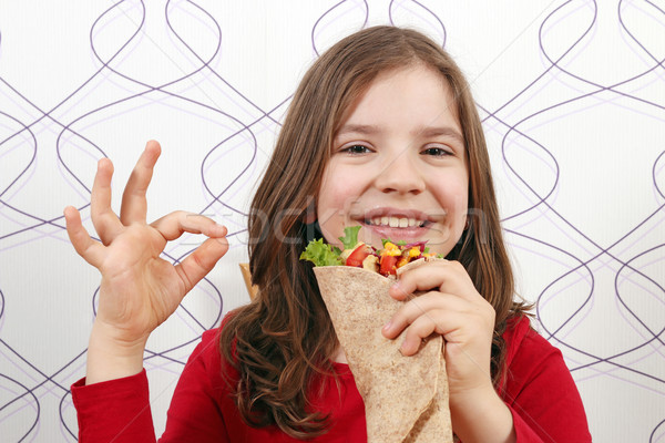 Happy little girl with burritos and ok hand sign Stock photo © goce