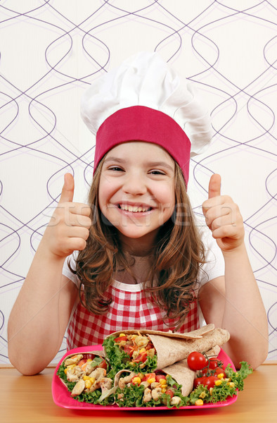 happy little girl cook with burritos and thumb up Stock photo © goce