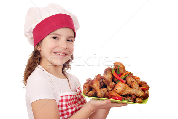 happy little girl cook with chicken drumstick Stock photo © goce