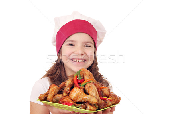 happy little girl cook with chicken drumsticks Stock photo © goce