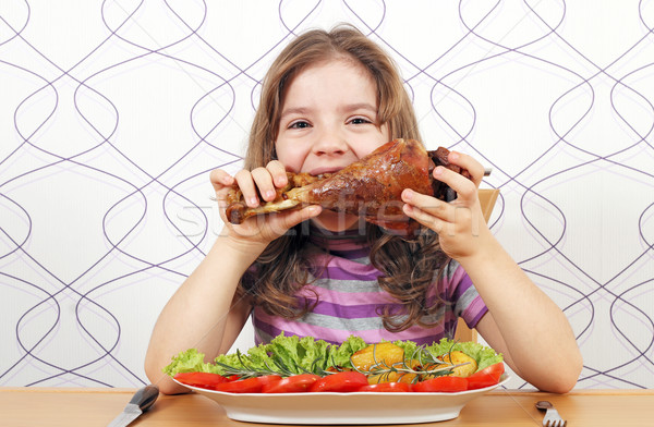 hungry little girl eating big turkey drumstick  Stock photo © goce