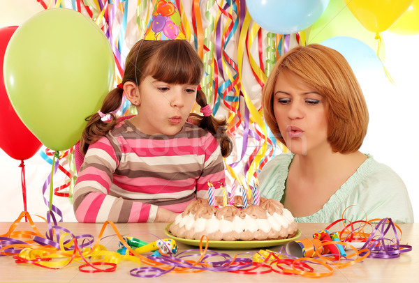 Mom and daughter blowing birthday candles  Stock photo © goce