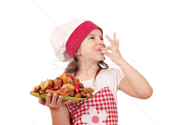happy little girl cook with chicken drumstick and ok hand sign Stock photo © goce