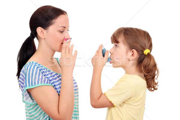 girl smoking cigarette and little girl with inhaler Stock photo © goce