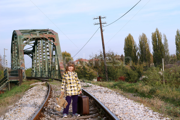 little girl with suitcase and teddy bear standing on railroad Stock photo © goce