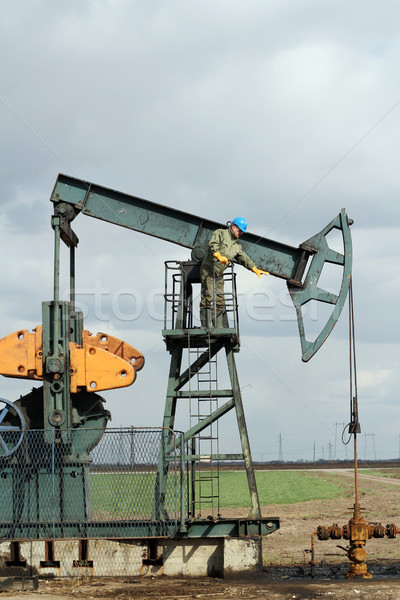 oilfield with worker and pump jack Stock photo © goce