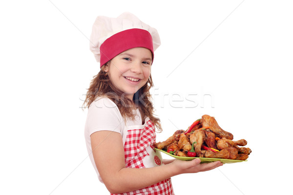 happy little girl cook with roasted chicken drumsticks Stock photo © goce