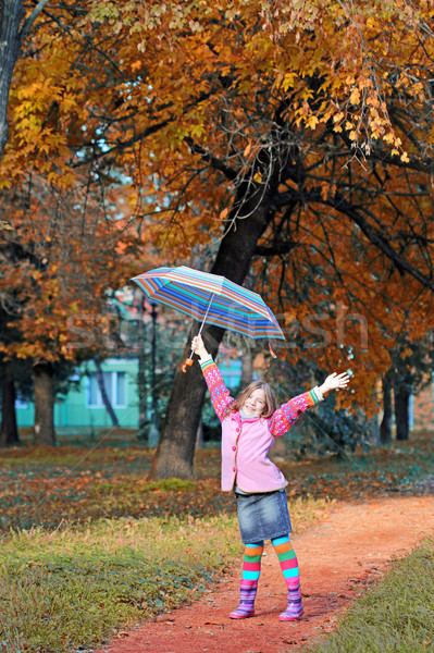 happy little girl with hand up in park autumn season Stock photo © goce