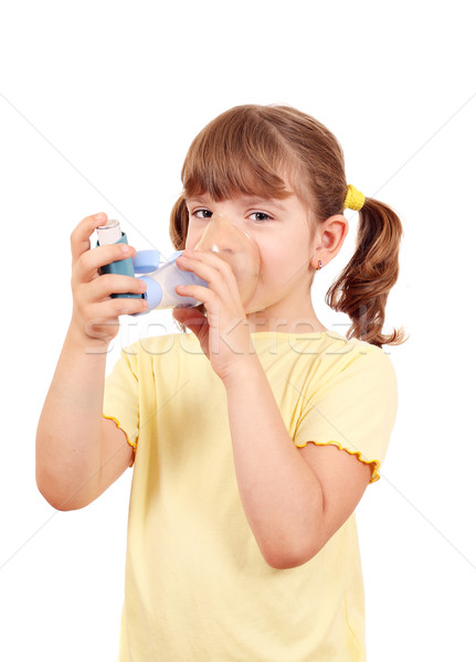 Stock photo: little girl using an asthma inhaler 