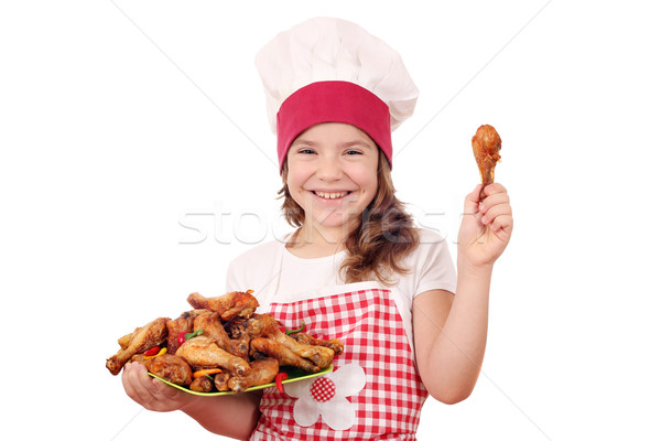 happy little girl cook with chicken drumstick Stock photo © goce