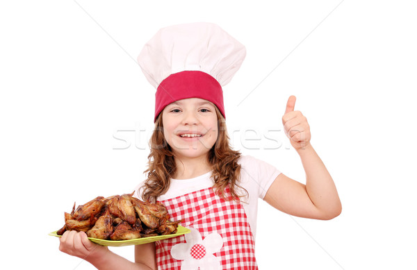 happy little girl cook with chicken wings and thumb up Stock photo © goce