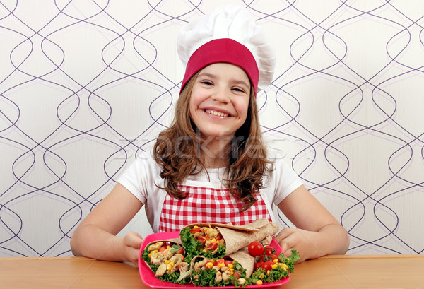 Happy little girl cook with burritos on plate Stock photo © goce