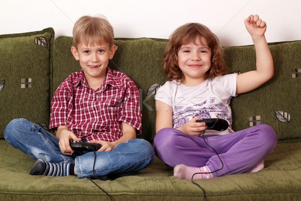 little girl and boy play video game Stock photo © goce