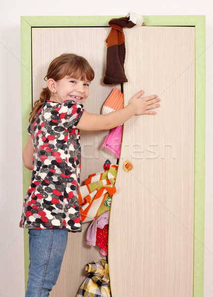 little girl trying to close messy closet  Stock photo © goce